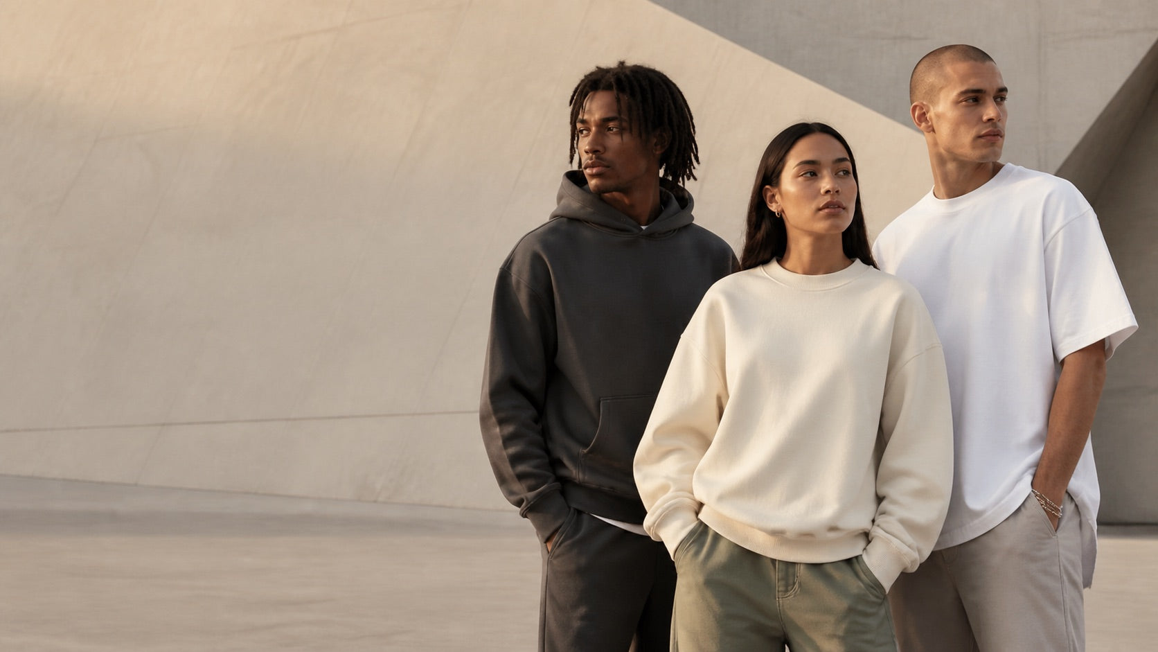 Three people wearing neutral everyday layers